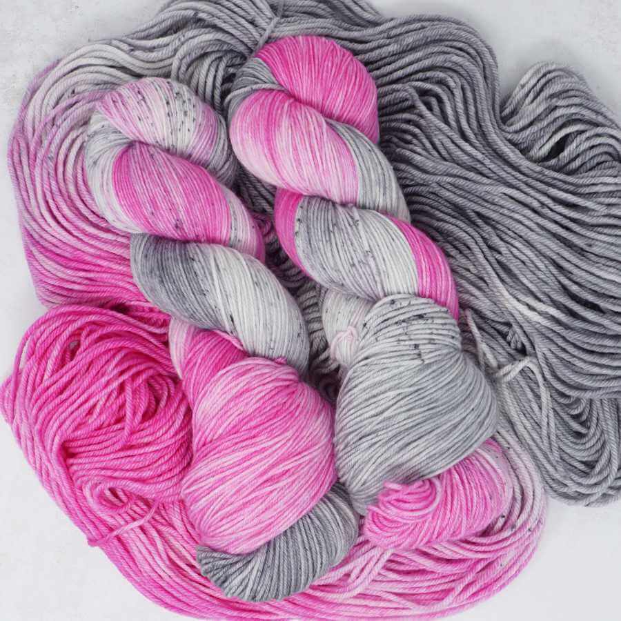 Hand dyed pink and grey speckled sock yarn skein in the Pink Elephant colourway by Market Town Yarns
