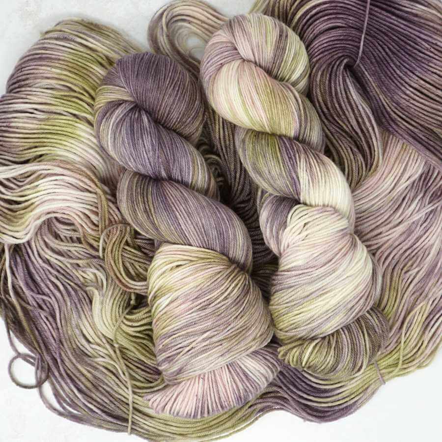 Thistle Mist hand-dyed yarn by Market Town Yarns in muted lavender, weathered sage, soft cream and delicate blush tones