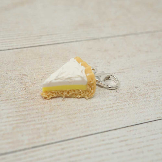 Keychain shaped like a slice of pie on a light wooden surface | Market Town Yarns