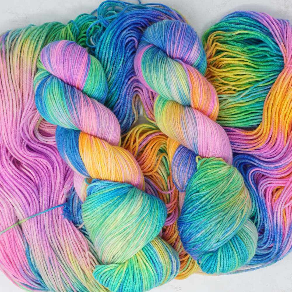 Rainbow Reef hand-dyed yarn featuring coral, turquoise, sea-green, lavender and golden tropical tones