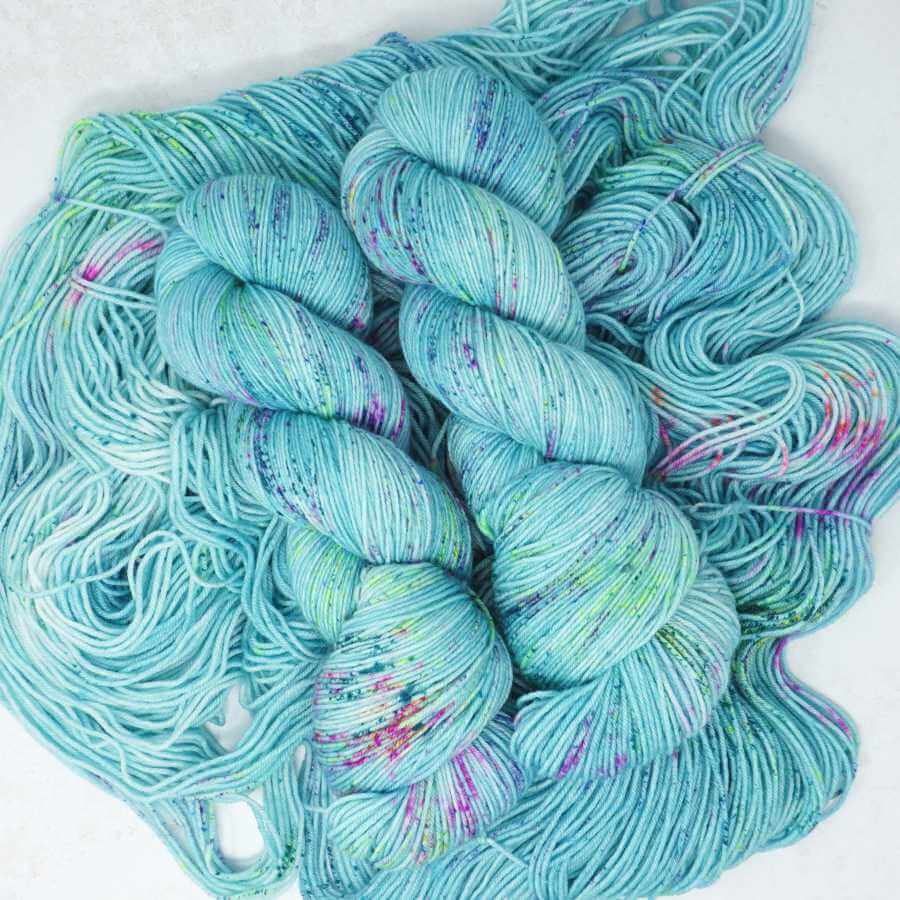 Atlantic Coast hand dyed yarn – soft aqua blue with pink, green and purple speckles on Squishy Sock | Market Town Yarns