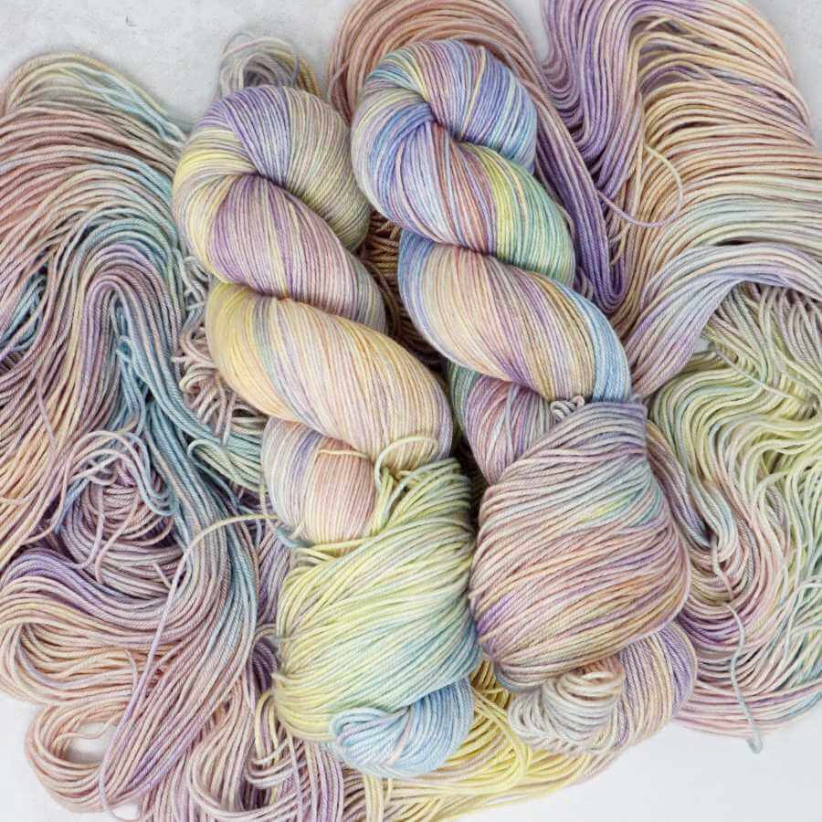 Sherbet Twist hand-dyed yarn by Market Town Yarns in pastel pink, lilac, buttery yellow and soft aqua tones