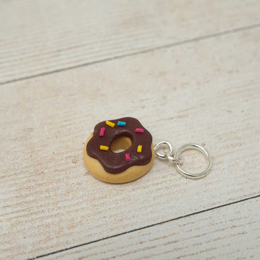 Donut-shaped keychain with chocolate glaze and sprinkles on a light wooden surface | Market Town Yarns