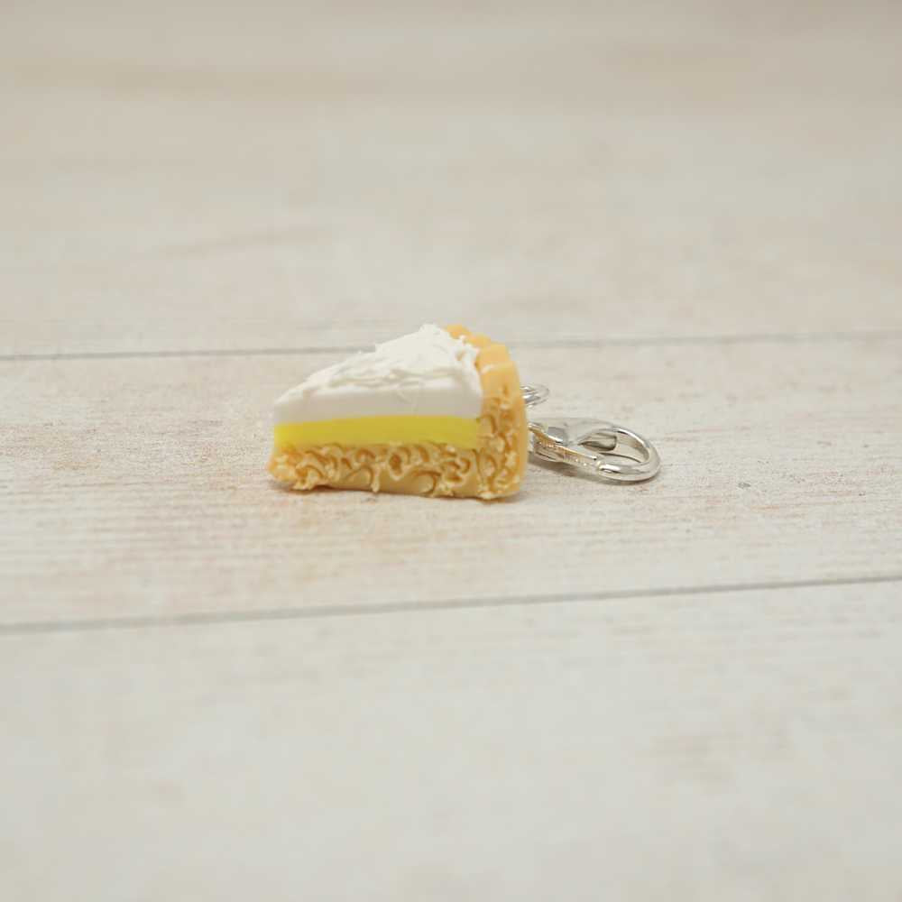 Miniature keychain of a slice of cake on a light wooden surface | Market Town Yarns