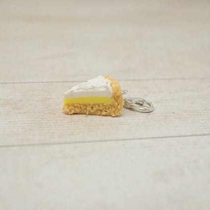 Miniature keychain of a slice of cake on a light wooden surface | Market Town Yarns