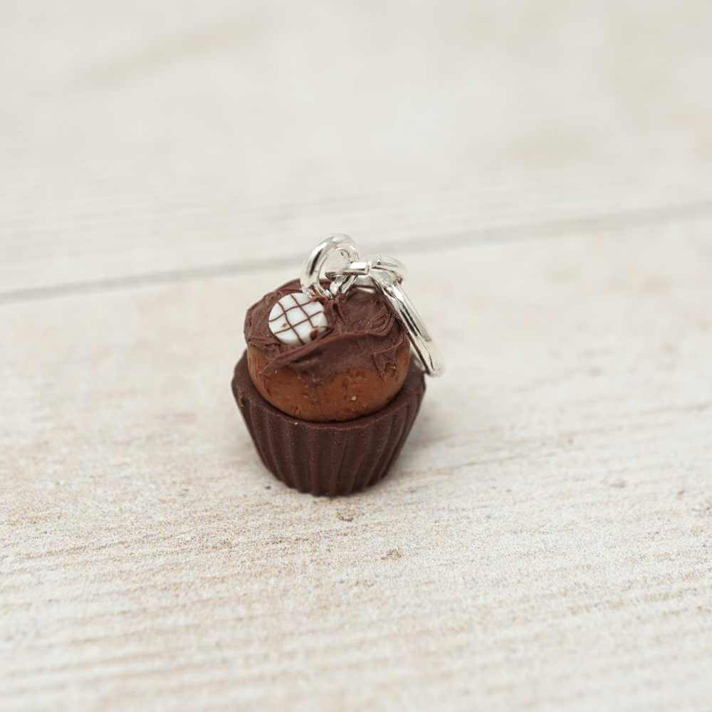 Small keychain shaped like a chocolate cupcake with a brown top on a light beige surface | Market Town Yarns