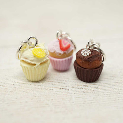 Three cupcake-shaped keychains on a textured surface | Market Town Yarns