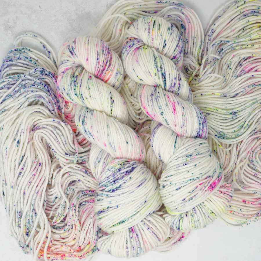 Sugar Rush hand dyed yarn with colourful neon speckles on a creamy white base | Market Town Yarns