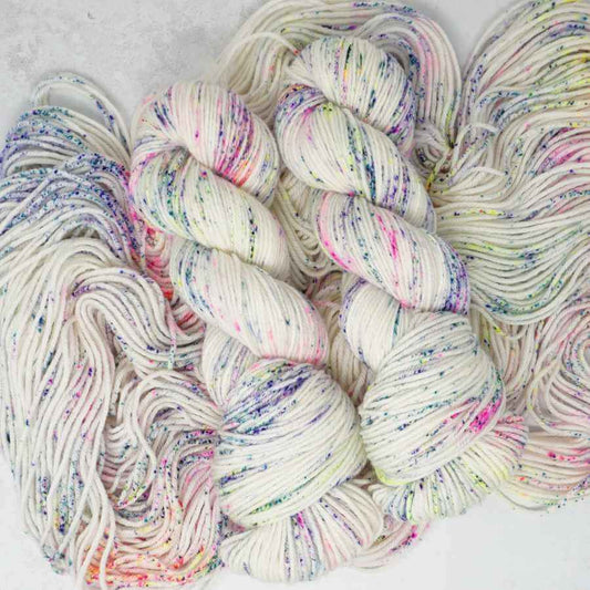 Sugar Rush hand dyed yarn with colourful neon speckles on a creamy white base | Market Town Yarns